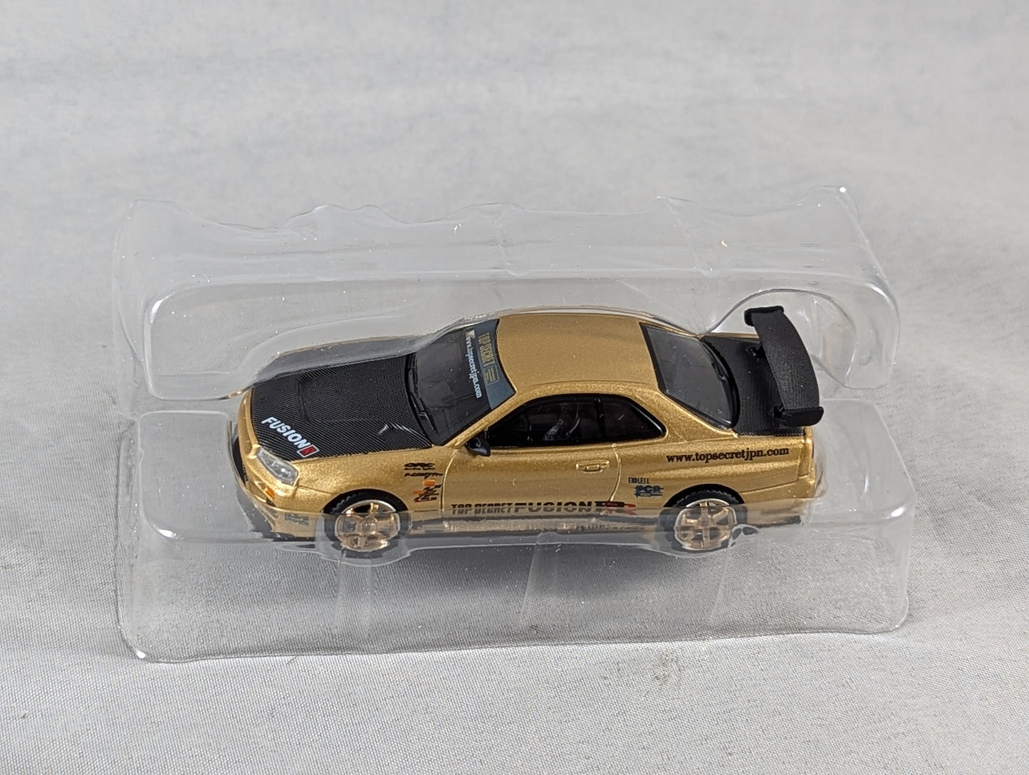 Mini GT Nissan Skyline GT-R (R34) Top Secret Gold