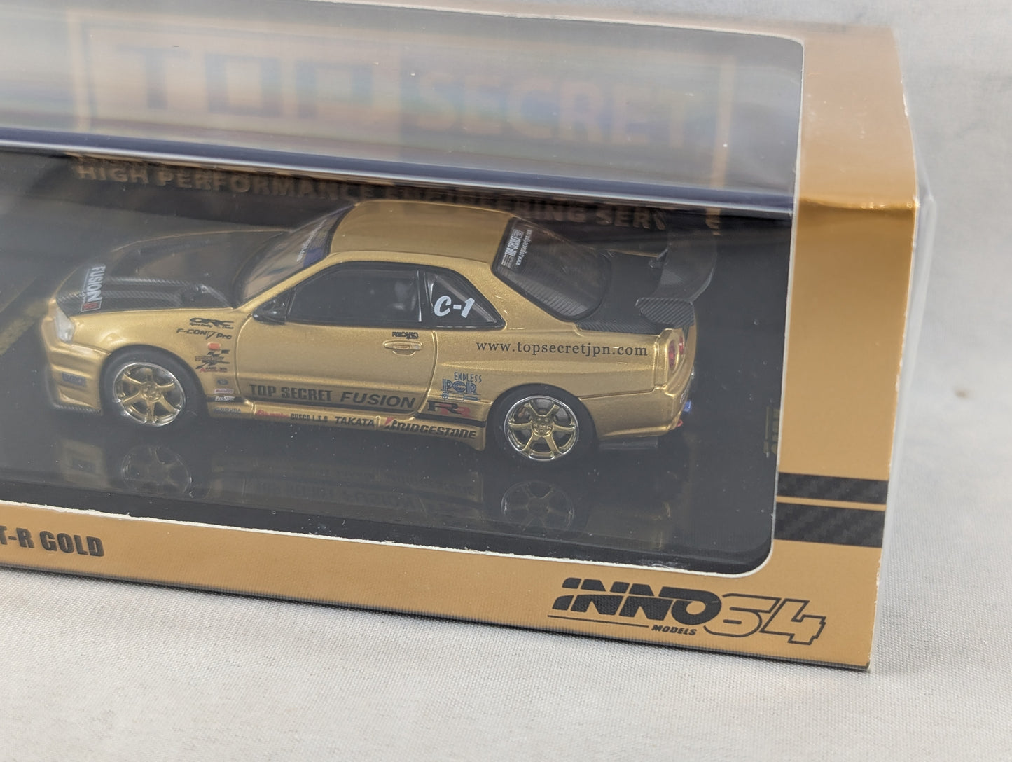 INNO64 Nissan Skyline GTR R34 Top Secret Gold
